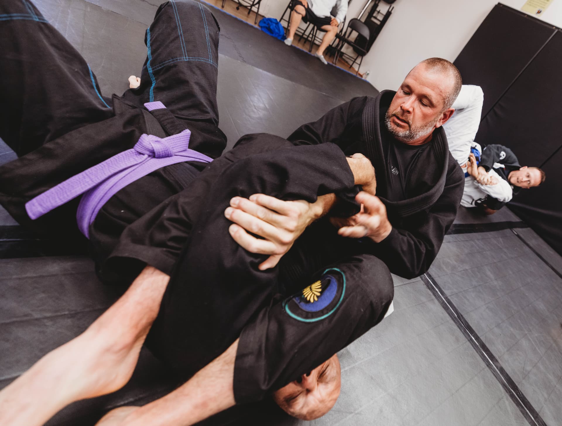 Brazilian Jiu-Jitsu students practicing a ground technique at Dandelion Jiu Jitsu in West Haven